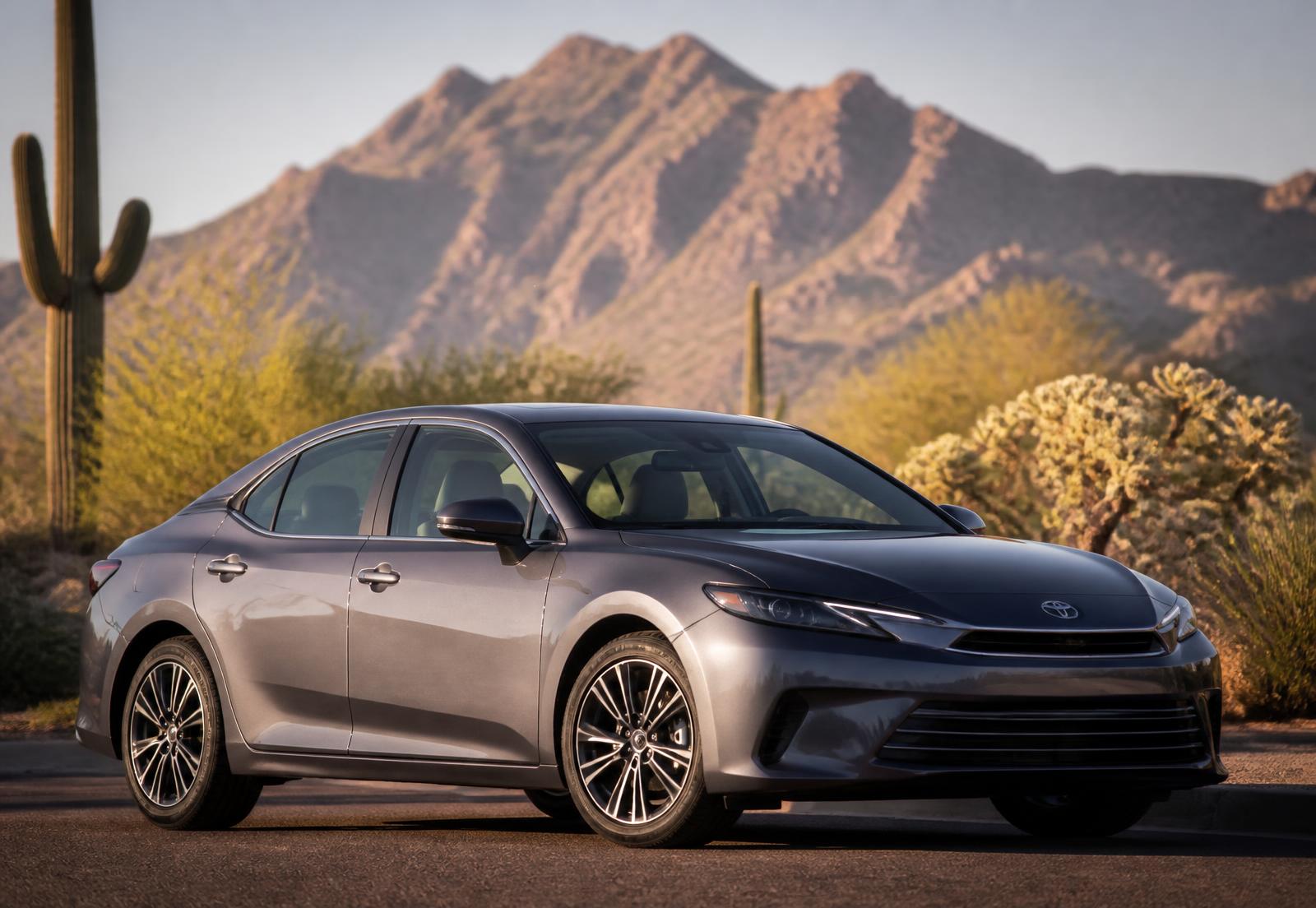 A car parked on a Tucson street with saguaro cactus and desert mountains behind it